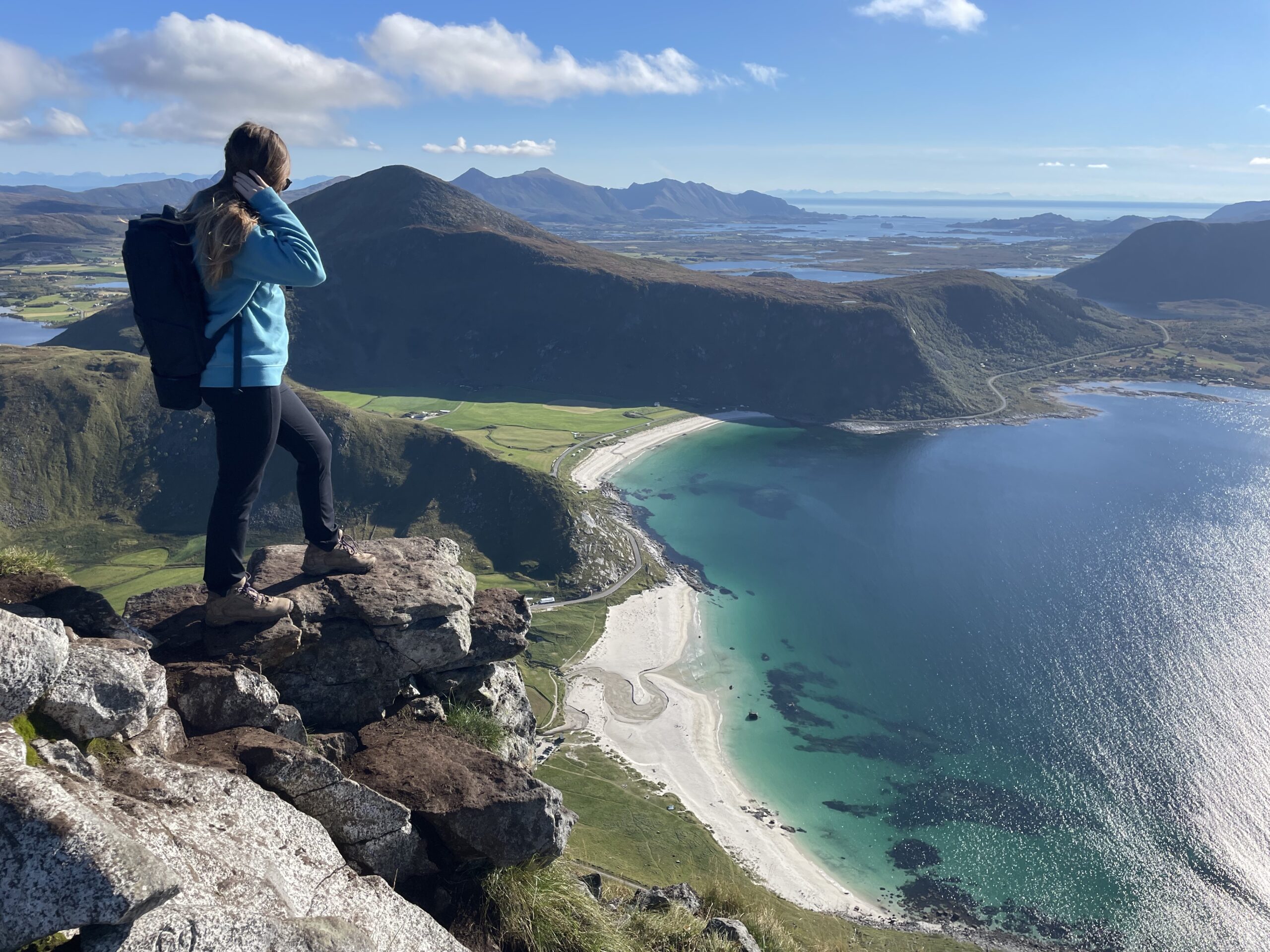 Janel overlooking cliff on top of mountain with ocean below