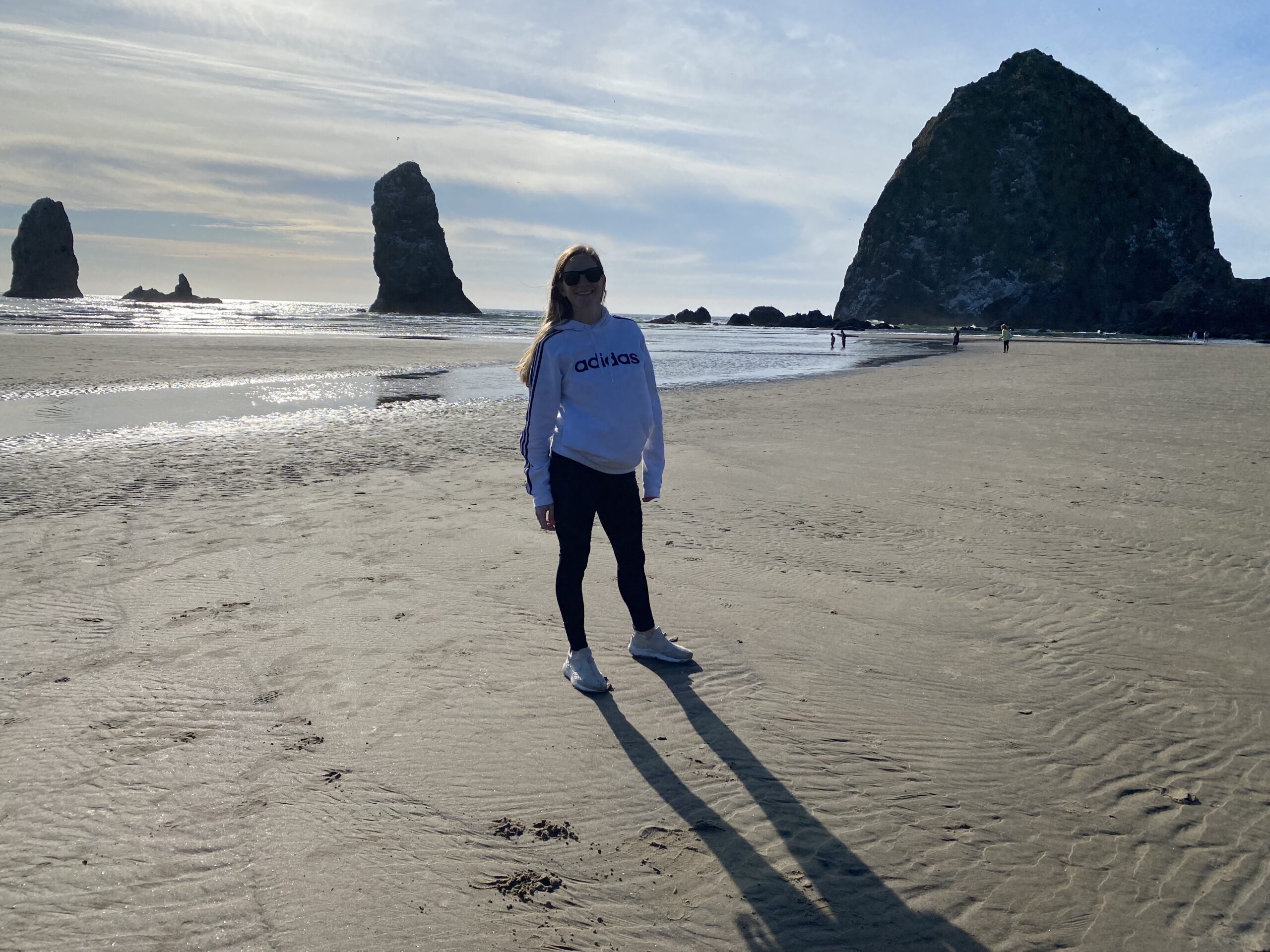 Janel standing on Cannon Beach with ocean in background